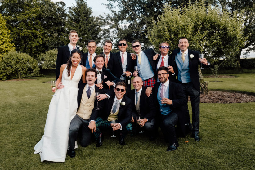 The bride and her friends posing for a photo at the family farm wedding.