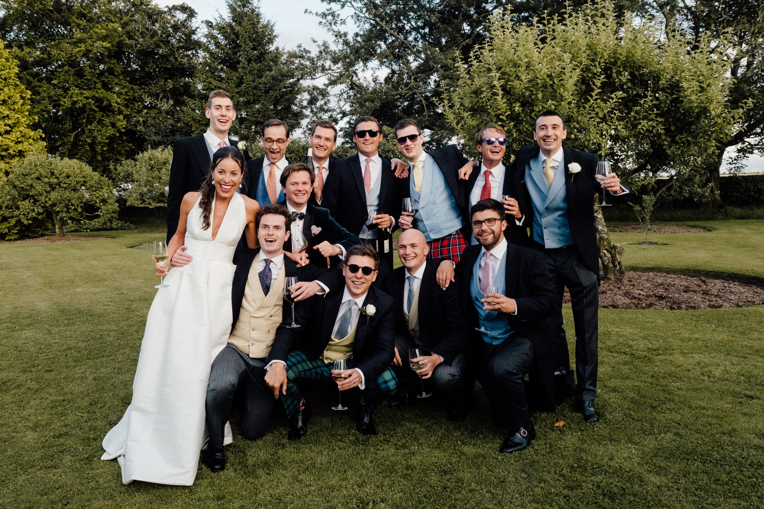 The bride and her friends posing for a photo at the family farm wedding.