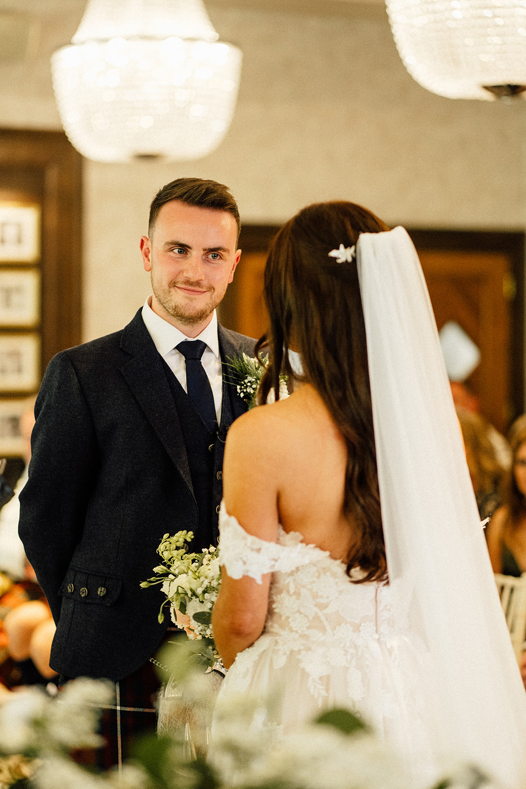 groom looking at the bride