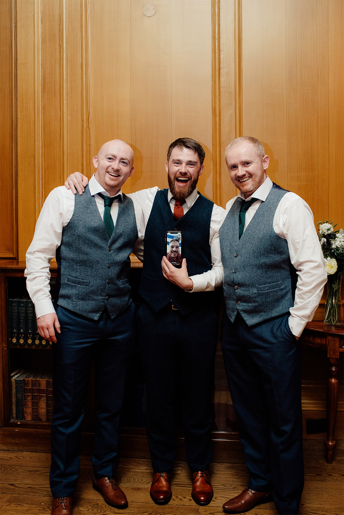 Groom posing with his groomsmen in a unique way.