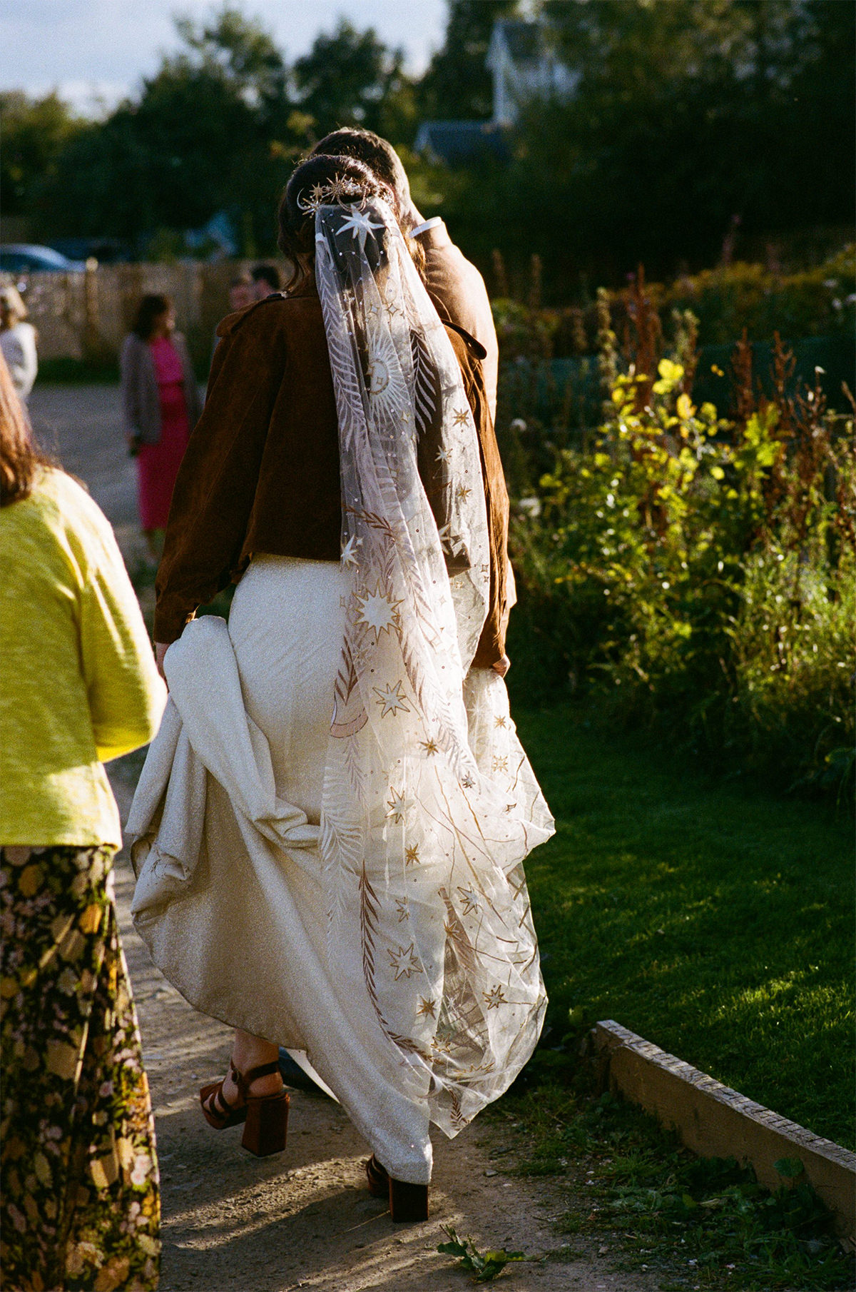 Bride wearing Rue de Seine veil arriving for the ceremony at the Secret Herb Garden.