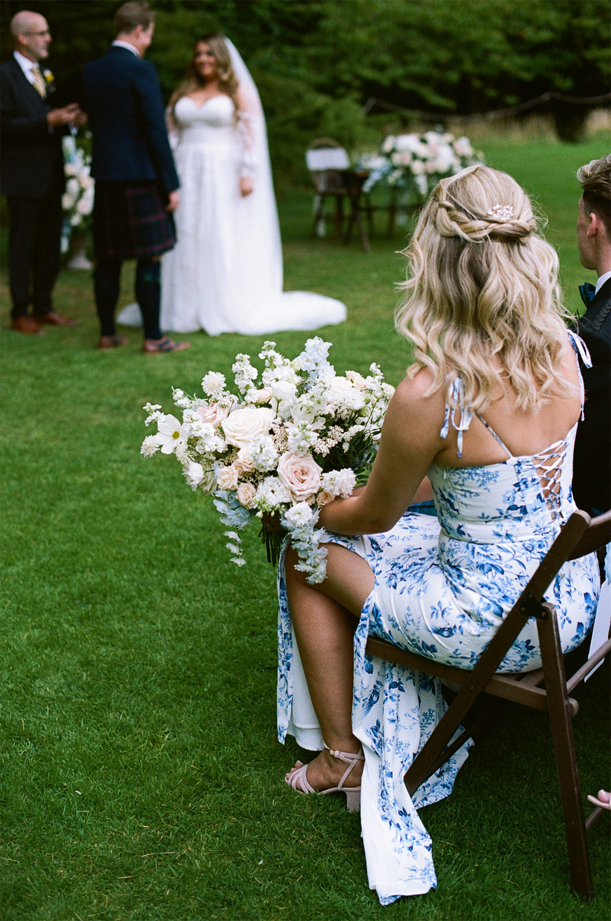 Photo of a bridesmaid wearing blue tile dress.