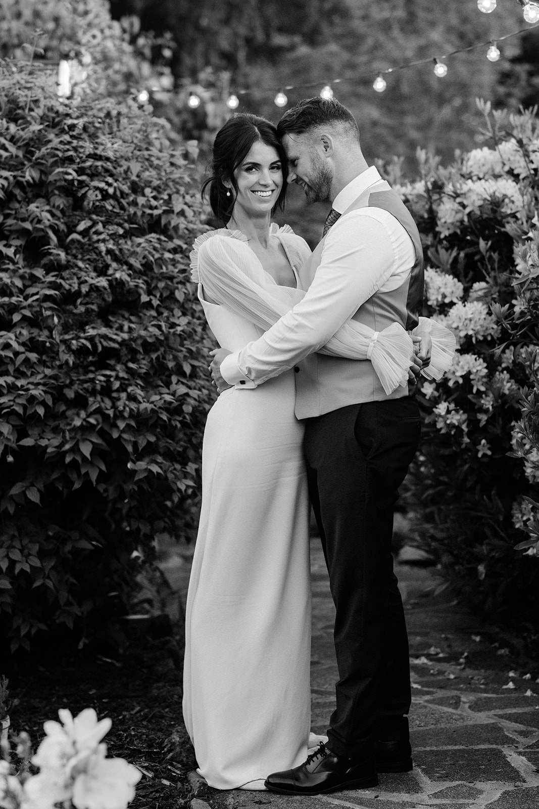 Wedding couple posing for the photos in their garden in the Borders.