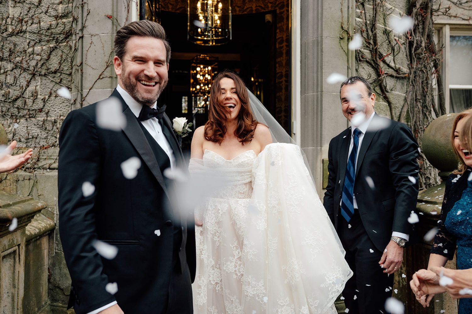 Bride and groom leaving Carlowrie Castle for confetti throw.