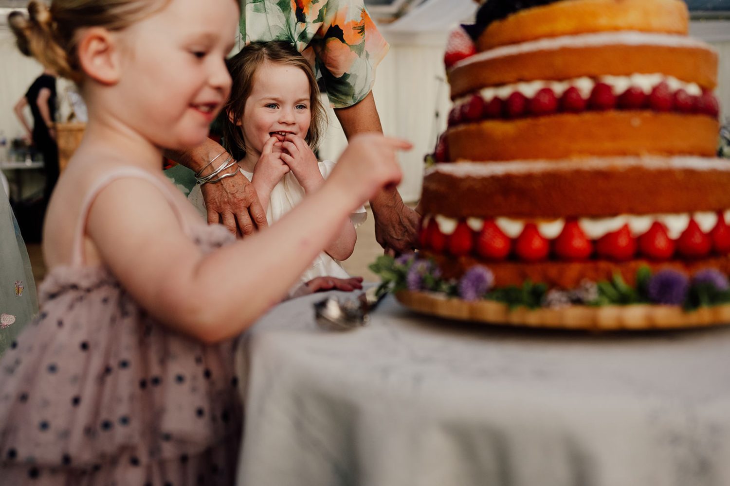 A child trying wedding cake in secret.
